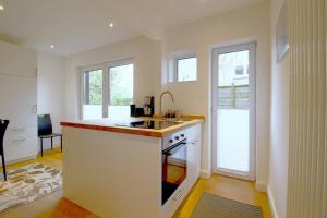 a kitchen with a sink and a stove top oven at NS 6 Strandläufer Wremen in Wremen
