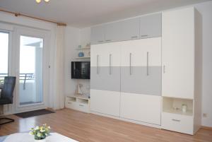 a large white cabinet in a living room at Hanseatic 204 in Duhnen