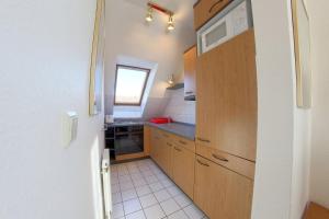 a small kitchen with a sink and a microwave at KD2-07 Schiffsjunge in Dorum-Neufeld
