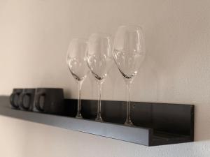 four wine glasses on a shelf on a wall at Wohnung im Zentrum von Gaggenau! in Gaggenau