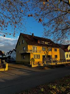 a yellow building with a sign on the side of it at Wohnung im Zentrum von Gaggenau! in Gaggenau