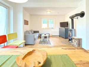 a living room with a couch and a wood stove at Kiefernwäldchen in Byhlen