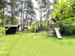 a playground in a yard with a swing at Kiefernwäldchen in Byhlen