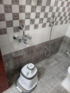 a toilet in a bathroom with a shower at Hotel Mount Royale in Hyderabad +39 photos