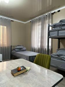 a room with two bunk beds and a table with an apple on it at Friends in Osh