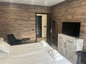 a bedroom with a bed and a flat screen tv at Къща за гости Бъчвата in Elkhovo