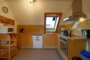 a small kitchen with a sink and a stove at KA6 Haus Küstenzeit in Wremen