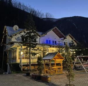 a house with a gazebo in front of it at Hotel Gryka in Peje +10 photos