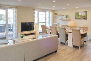 a living room with a couch and a table with a tv at Quartier Spreestraße - App 5 in Burg
