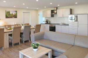 a living room and kitchen with a couch and a table at Quartier Spreestraße - App 5 in Burg