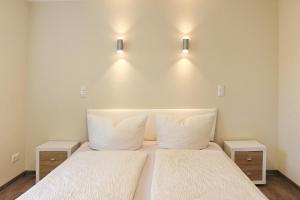 a bedroom with two beds and two night stands at Quartier Spreestraße - App 5 in Burg