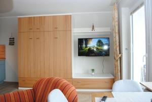 a living room with a tv on a wooden cabinet at Hanseatic 512 in Duhnen
