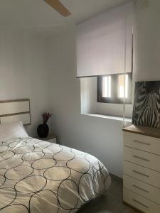 a white bedroom with a bed and a window at Casita Mona Marcoin in Toledo +7 photos