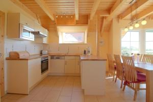 a large kitchen with a table and a dining room at SV3 Mellumplate 56 in Dorum-Neufeld