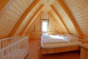 a bedroom with a bed in the attic at SV3 Mellumplate 56 in Dorum-Neufeld +6 photos