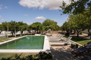 a swimming pool with lounge chairs next to at Eighteen21 Houses - Casa dos Condes in Cano