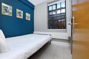 a small room with a bed and a window at Rest Up London in London