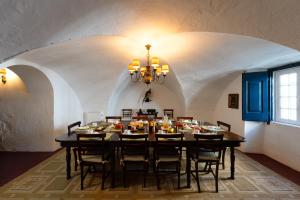 a dining room with a black table and chairs at Eighteen21 Houses - Casa dos Condes in Cano