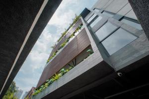 a house with plants on the side of it at Koji House in Jakarta