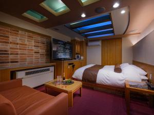 a hotel room with a bed and a couch at Water Hotel Mw 岩槻 -Adult only- Love Hotel in Saitama