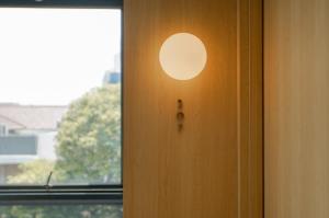 a door with a light on it next to a window at Koji House in Jakarta +13 photos