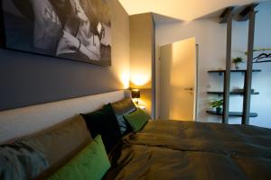 a bedroom with a bed and a couch in a room at RK Private Residence in Trautmannsdorf an der Leitha