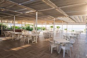 an empty restaurant with tables and chairs in ailion at Silver Hotel in Side