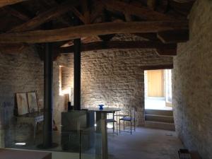 a room with a table and chairs and a brick wall at Equisoain Ala Sur in Monreal