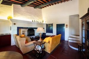 a living room with couches and a fireplace at Eighteen21 Houses - Casa dos Condes in Cano
