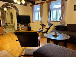 a living room with a couch and a table at Chata Rychnovanka in Zdobnice