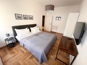 a bedroom with a bed and a flat screen tv at ✪ FirstClass-Apartment in Leipzig-Gohlis ✪ in Leipzig