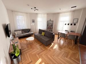 a living room with a couch and a table at ✪ FirstClass-Apartment in Leipzig-Gohlis ✪ in Leipzig
