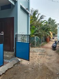 a blue door on the side of a house at Nandy Delight Homestay in Kanyakumari