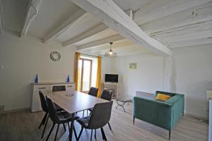 a living room with a table and a couch at Gîte 87G7461 in Saint-Mathieu