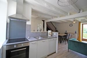 a kitchen with a sink and a stove at Gîte 87G7461 in Saint-Mathieu