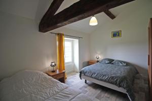 a bedroom with a bed and a window at Gîte 87G7461 in Saint-Mathieu