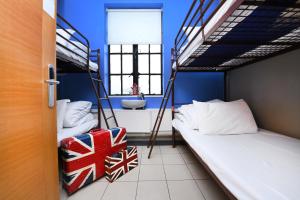 a room with two bunk beds and a bathroom at Rest Up London in London