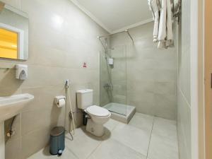 a bathroom with a toilet and a shower and a sink at Sunshine Pyramids& Grand Museum View in Cairo
