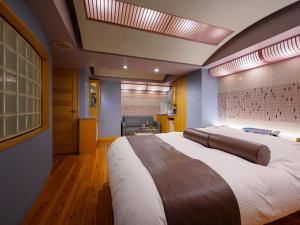 a bedroom with a large bed in a room at Water Hotel Mw 岩槻 -Adult only- Love Hotel in Saitama