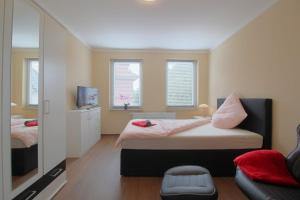 a bedroom with two beds and a mirror at Gästehaus Dorum 02 in Dorum