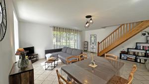 a living room with a table and a couch at Neuville in Saint-Mathieu