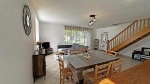 a living room with a table and a couch at Neuville in Saint-Mathieu +16 photos