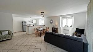 a living room with a couch and a table at Neuville in Saint-Mathieu