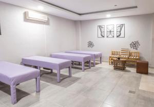 a waiting room with purple benches and a piano at Silver Hotel in Side