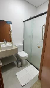 a bathroom with a toilet and a sink and a shower at Florida Limeira Hotel in Limeira +17 photos