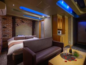 a hotel room with a bed and a couch at Water Hotel Mw 岩槻 -Adult only- Love Hotel in Saitama