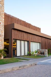 a building with a wooden facade with windows at Studio River 101 in Pôrto de Pedras