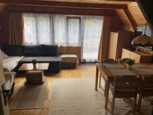 a living room with a couch and a table at chata u Ondrucha in Tři Studně