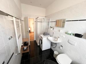 a white bathroom with a sink and a toilet at FirstClass 2R_Apartment in Leipzig in Leipzig +12 photos
