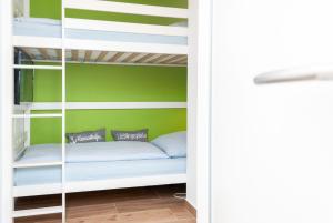 a bunk bed in a room with green walls at Hanseatic 111 in Duhnen +18 photos